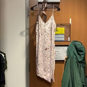 A baby pink velvet dress with a slit on the side